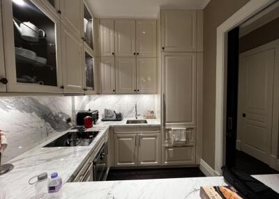 Modern kitchen with marble countertops and white cabinets