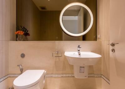 Modern bathroom with circular mirror and sink