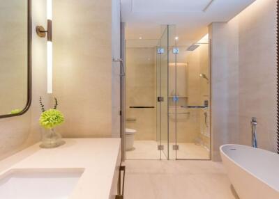 Modern bathroom with glass shower enclosure and bathtub