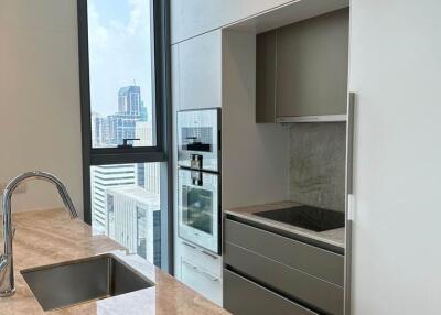 Modern kitchen with marble countertop and built-in appliances