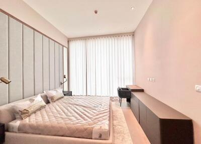 Spacious bedroom with modern furnishings and large window