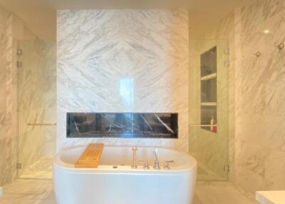 Modern bathroom with standalone bathtub and marble finish