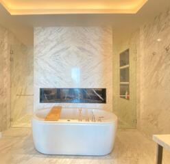 Modern bathroom with standalone bathtub and marble finish