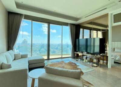 Spacious living room with large windows and a city view