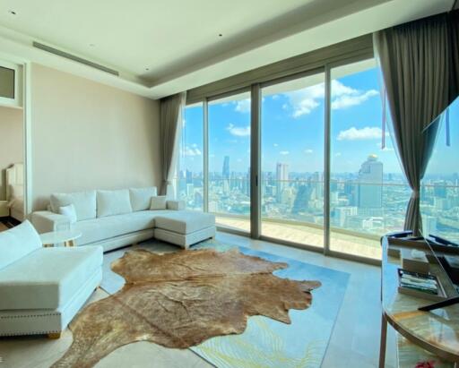 Spacious living room with large windows and city view