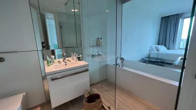 Modern bathroom with bathtub and view into bedroom