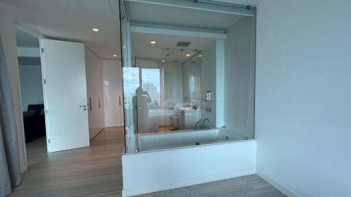 Modern bathroom with a glass-enclosed bathtub