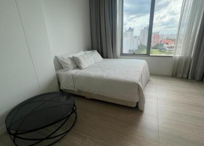 Modern bedroom with a large window and city view