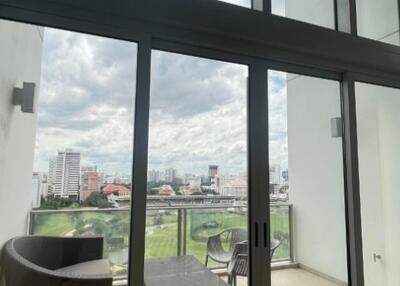 Spacious living area with large windows and balcony view