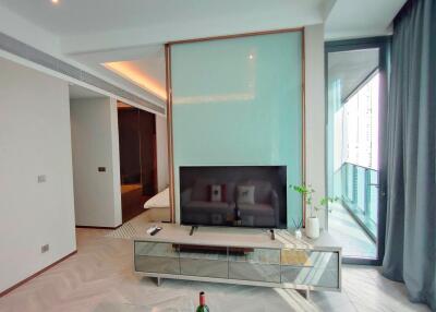 Modern living room with TV, glass door, and balcony