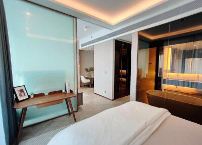 Modern bedroom with a view of a stylish bathroom and a corner desk