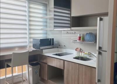 Modern kitchen with appliances and bar stool