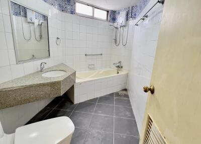 Modern white bathroom with bathtub and large mirror