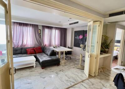 Living room with sectional sofa, coffee table, and large glass doors