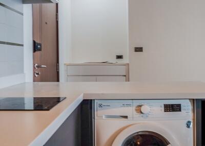 Modern kitchen with washing machine and induction cooktop