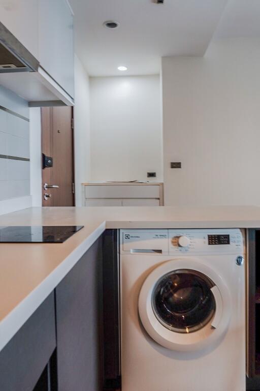 Modern kitchen with washing machine and induction cooktop