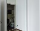 Hallway with mirrored wardrobe and view into bathroom