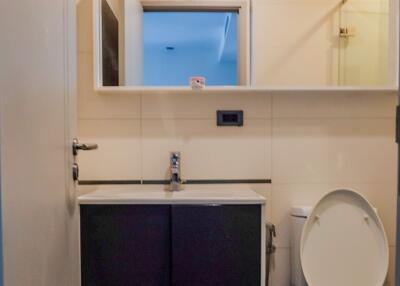 Bathroom with vanity, mirror, and toilet