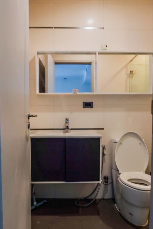 Bathroom with vanity, mirror, and toilet