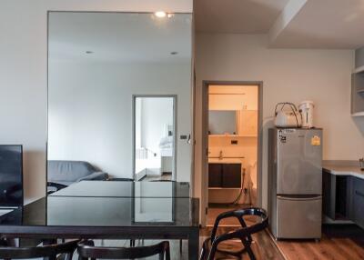 Main living area with a dining table, sofa, and kitchen