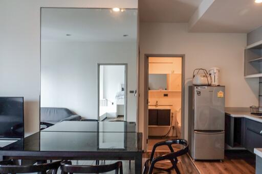 Main living area with a dining table, sofa, and kitchen