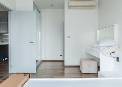 Modern minimalist bedroom with wooden flooring