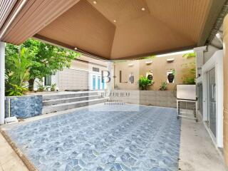 Covered outdoor area with tiled flooring and decorative walls