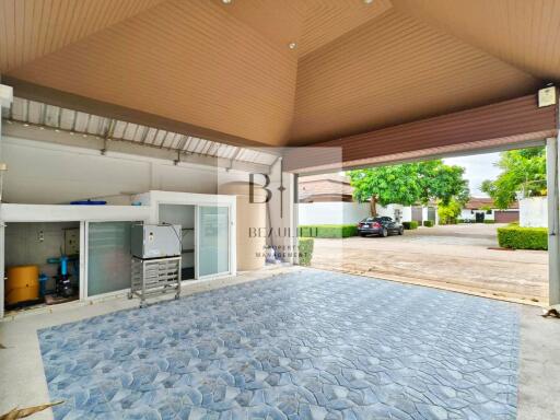 Covered garage with tiled floor and storage area