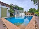 Outdoor swimming pool with surrounding tropical vegetation