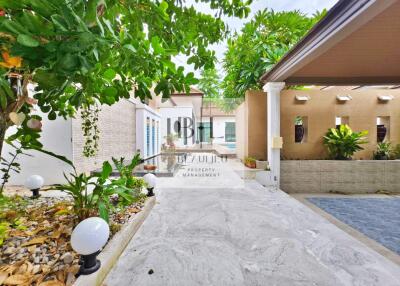 Outdoor area with driveway and greenery