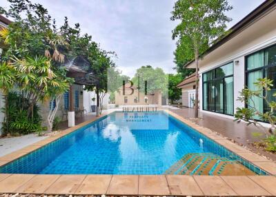 Outdoor area with swimming pool and surrounding greenery