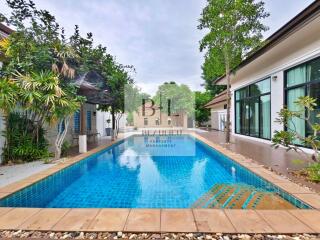 Outdoor area with swimming pool and surrounding greenery