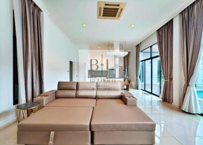 Modern living room with beige sofa and large windows