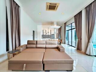 Modern living room with beige sofa and large windows