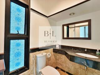 Modern bathroom with a unique blue-patterned window