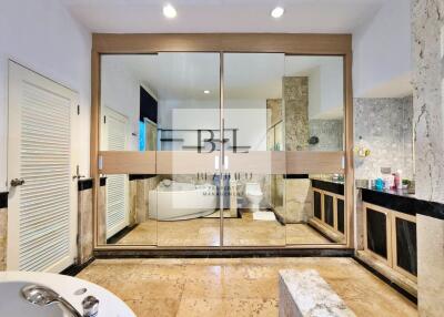 Spacious bathroom with modern amenities and large mirrors