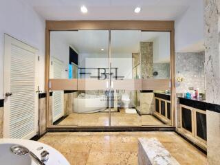 Spacious bathroom with modern amenities and large mirrors