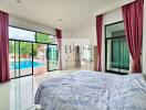 Bedroom with pool view and large windows