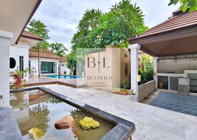 Spacious and serene outdoor area with a swimming pool and garden