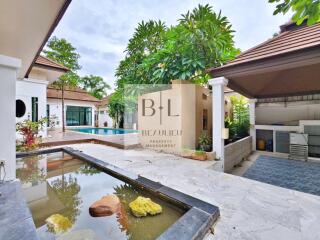 Spacious and serene outdoor area with a swimming pool and garden