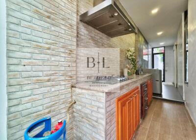 Modern kitchen with brick accents and wooden cabinets