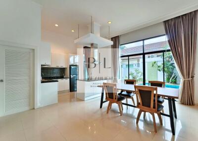 Modern dining area with large windows and pool view