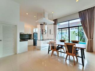 Modern dining area with large windows and pool view