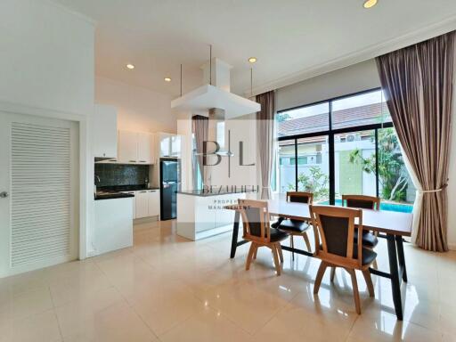 Modern dining area with large windows and pool view