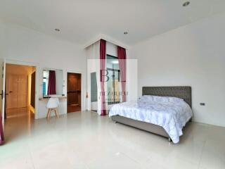 Spacious modern bedroom with en-suite bathroom and study area