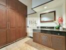 Elegant bathroom with wooden cabinets and black countertop