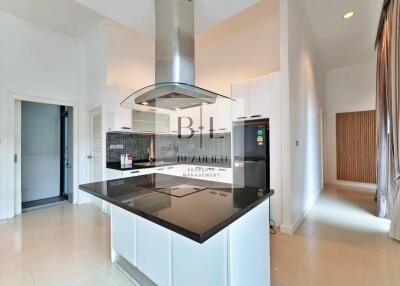 Modern kitchen with island and black countertop