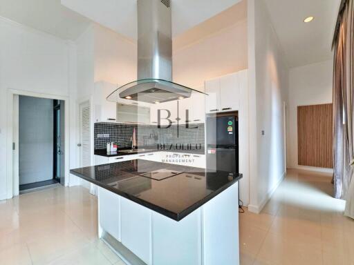 Modern kitchen with island and black countertop