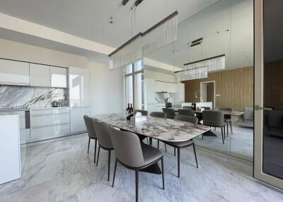 Modern dining area with a marble table and chairs