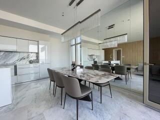 Modern dining area with a marble table and chairs